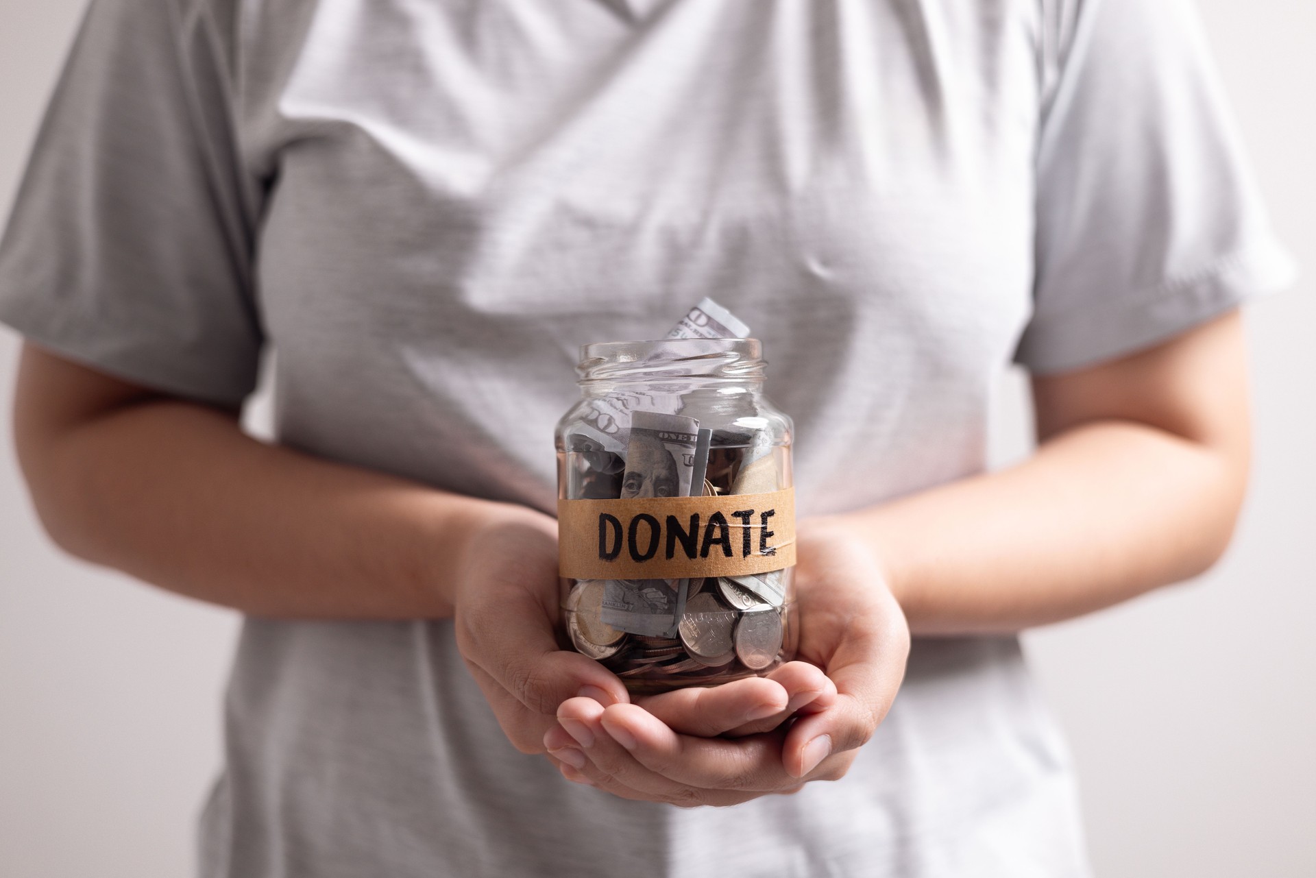 Manage her income wisely she used jar to save coins and cash, balancing her financial needs between finance and desire to donate money. money, coin, finance, jar, financial, save, cash, donate.